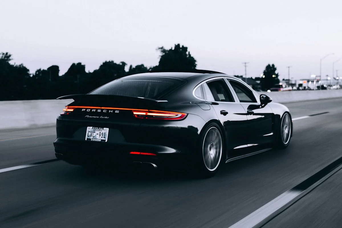 Black Porsche Panamera four-door sports saloon photographed in profile.