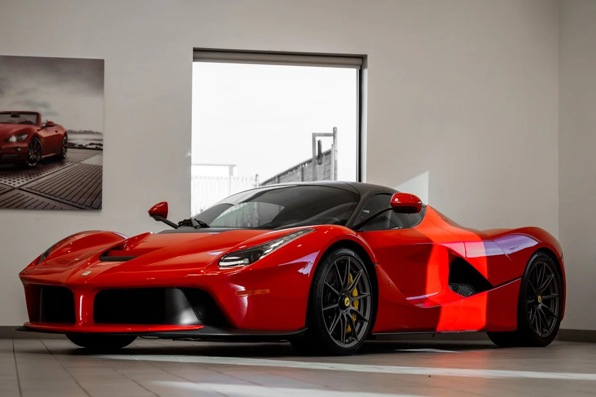 Red Ferrari two-seat sports car photographed low from the front three-quarter.